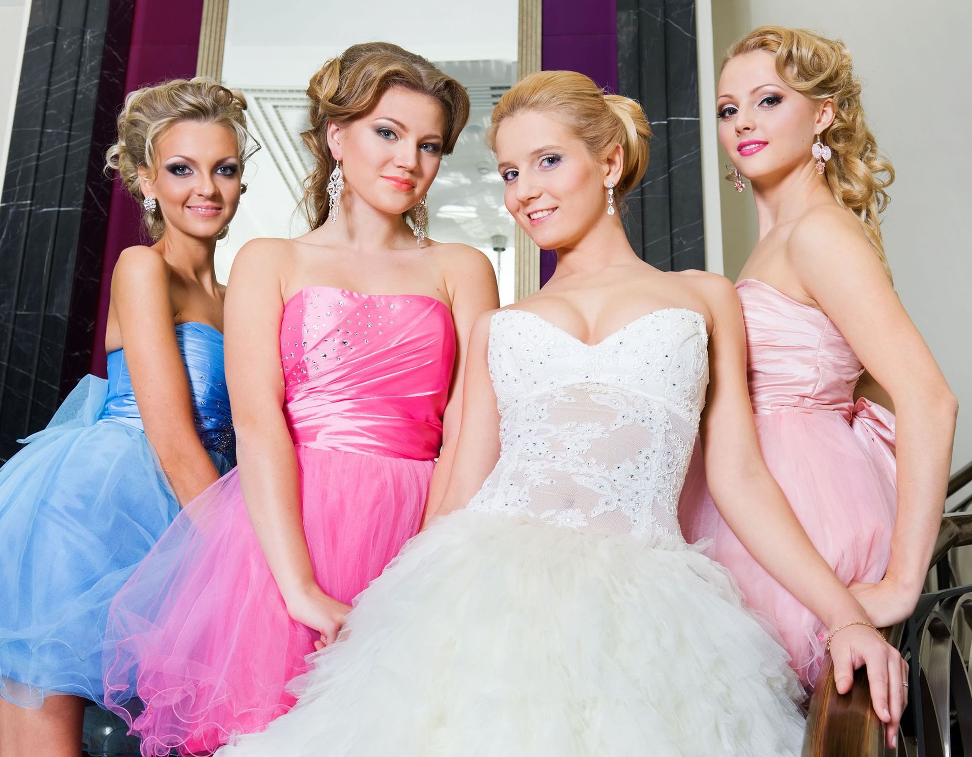 A bride and her bridesmaids are posing for a picture