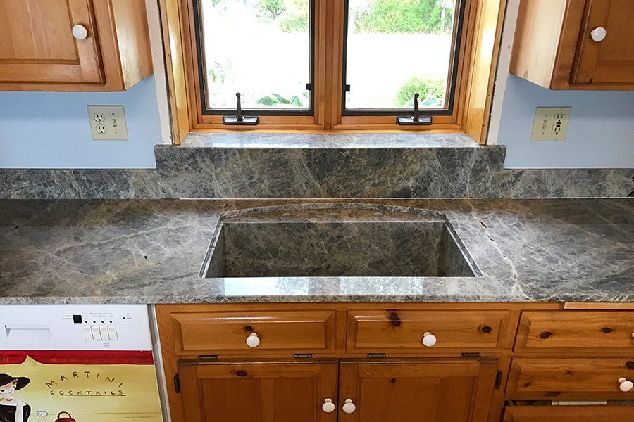 A kitchen counter with a sink and a window
