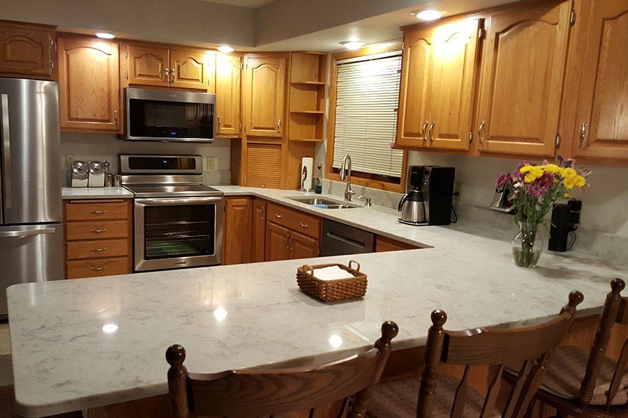 A kitchen with stainless steel appliances and wooden cabinets