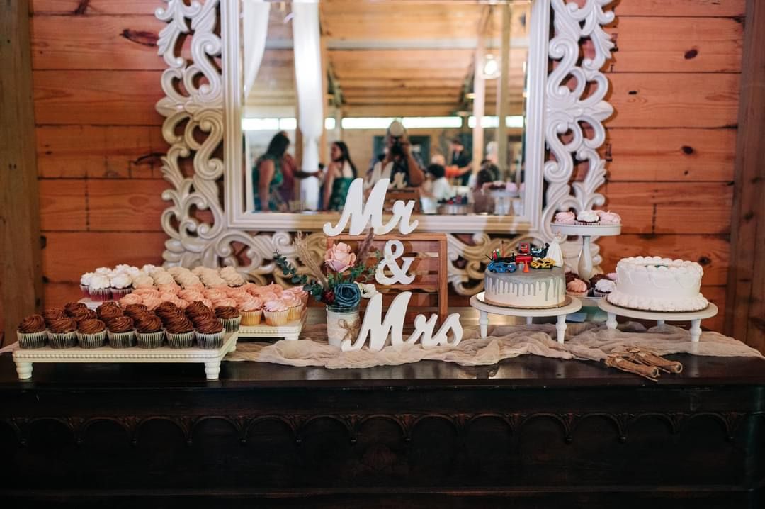 There is a table with a sign that says mr. and mrs. on it.