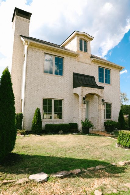 A large white house with a chimney on top of it