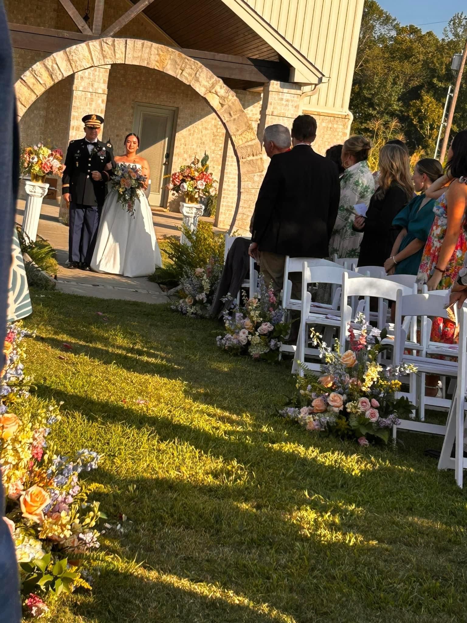 A bride and groom are walking down the aisle at a wedding ceremony.
