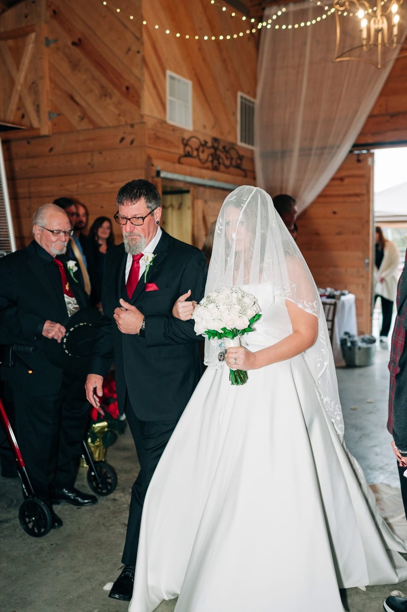 A bride is walking down the aisle with her father