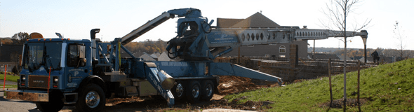 Concrete pumping truck with extended boom in residential site