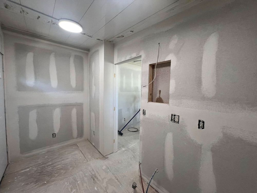 Room under construction with drywall installed.  Electrical boxes and an alcove are visible.
