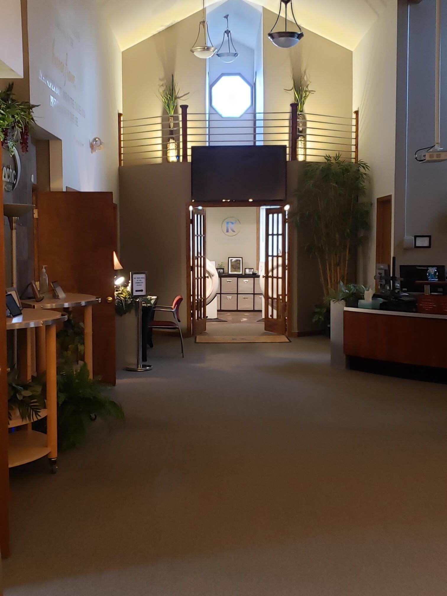 A very long hallway in a building with a balcony
