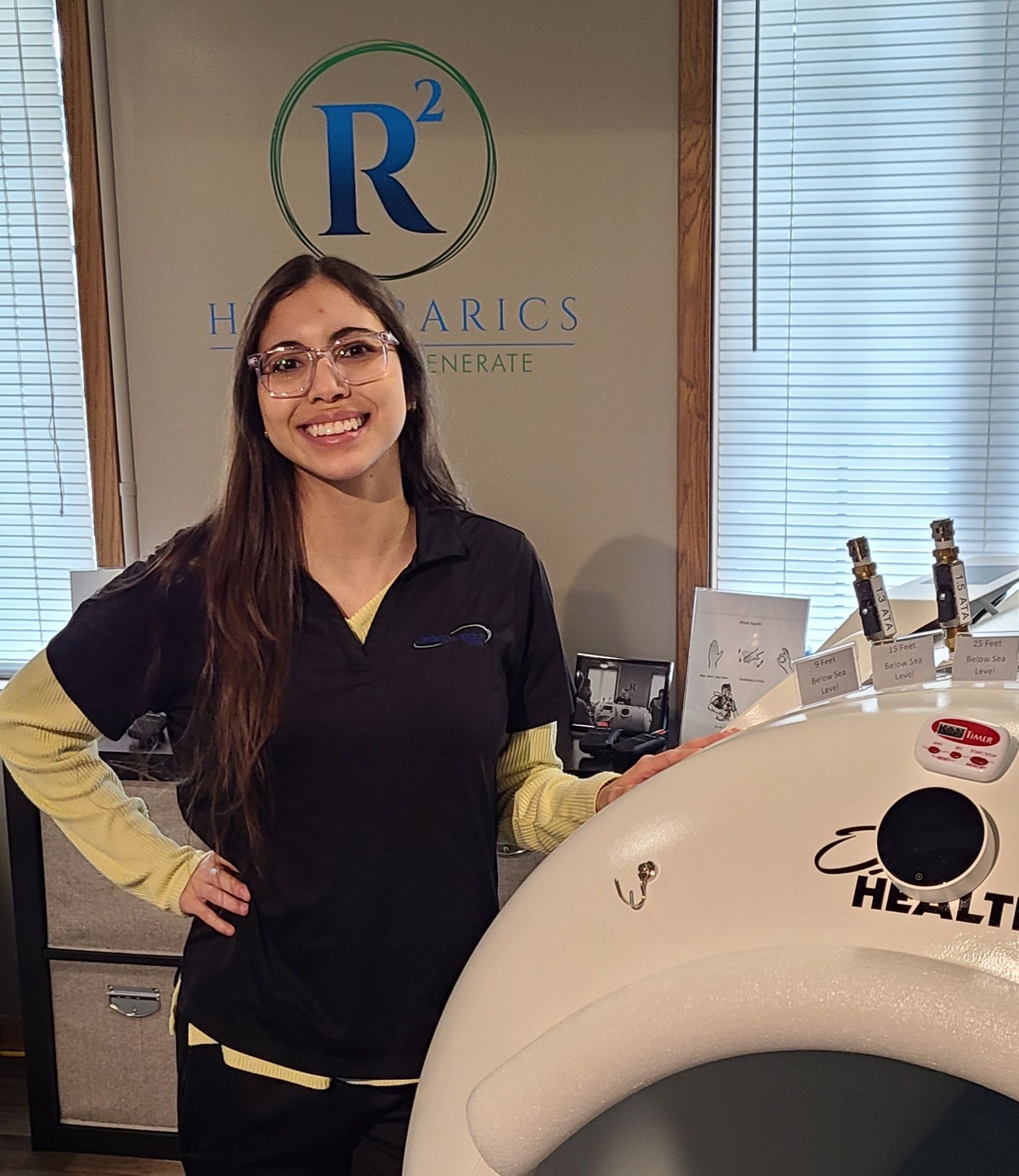 A woman in a black shirt is standing next to a large white object.