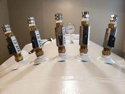 A group of valves are sitting on top of a white table.