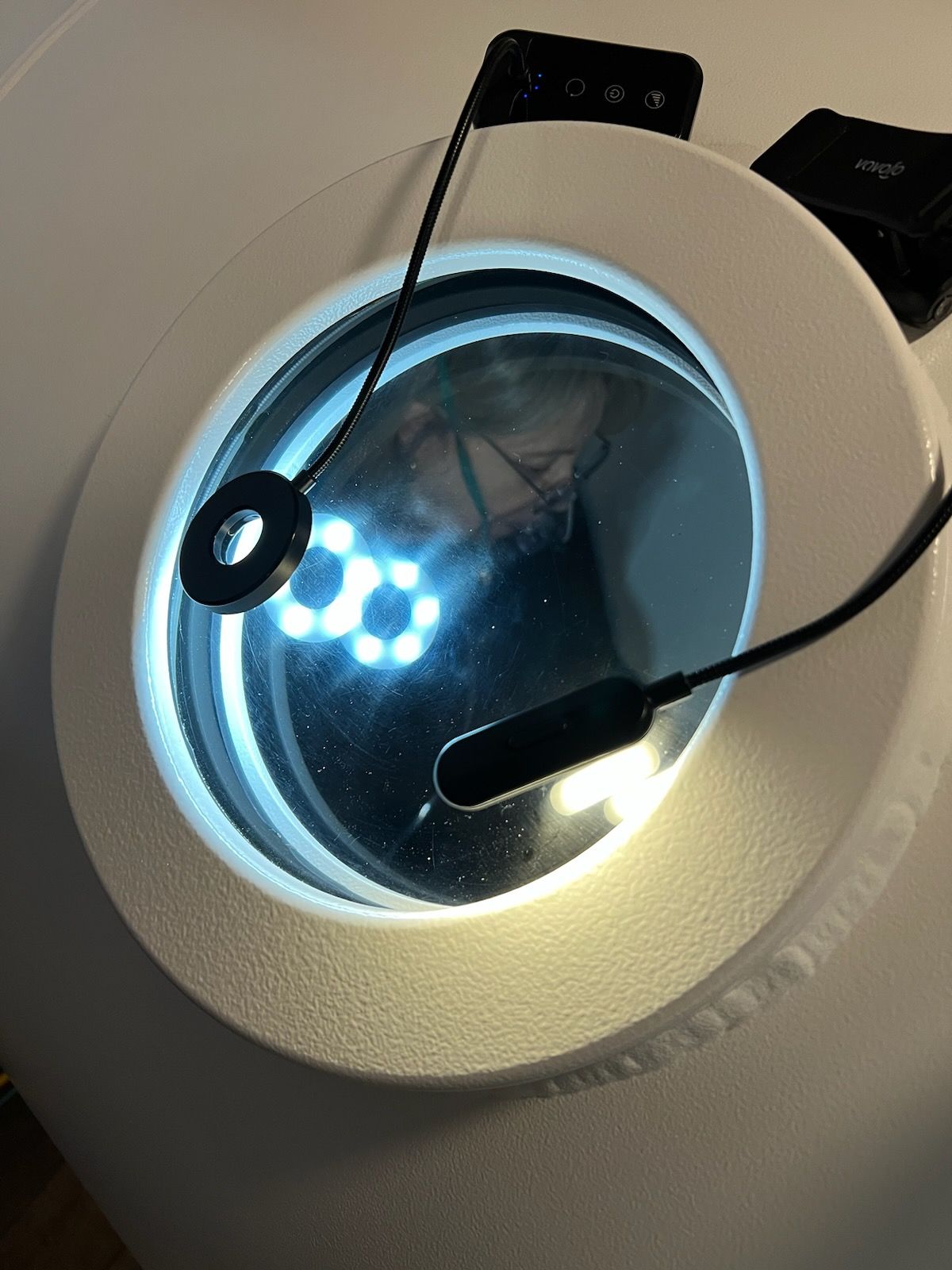 A magnifying glass with a microphone attached to it