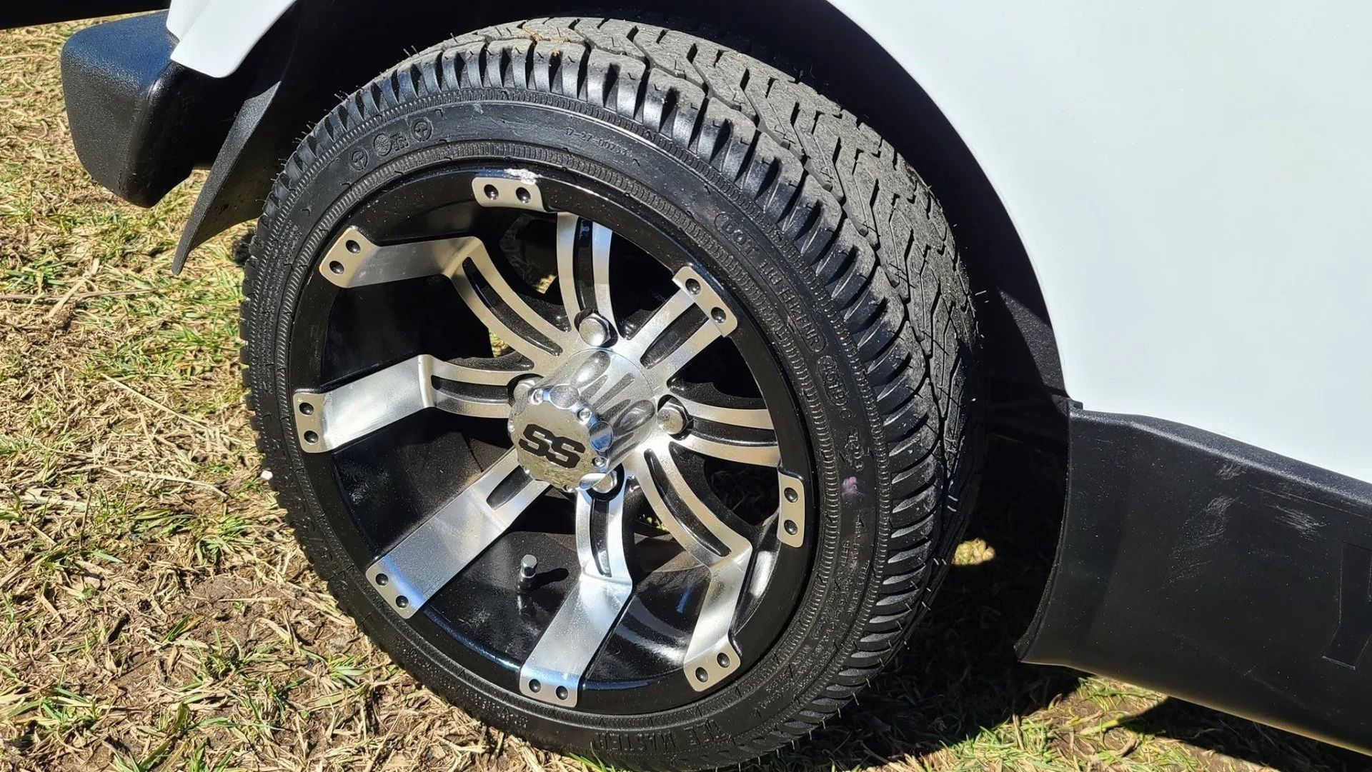 A close up of a wheel on a golf cart