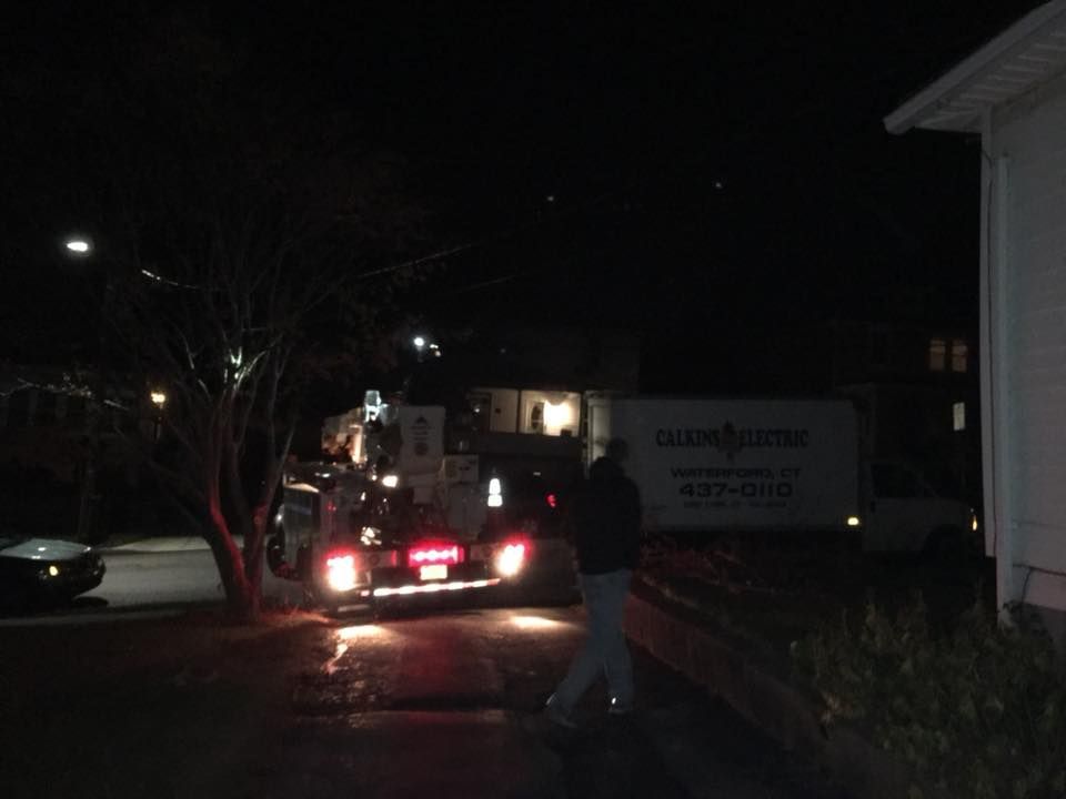 A man walking in front of a white truck that says ' moving company ' on it