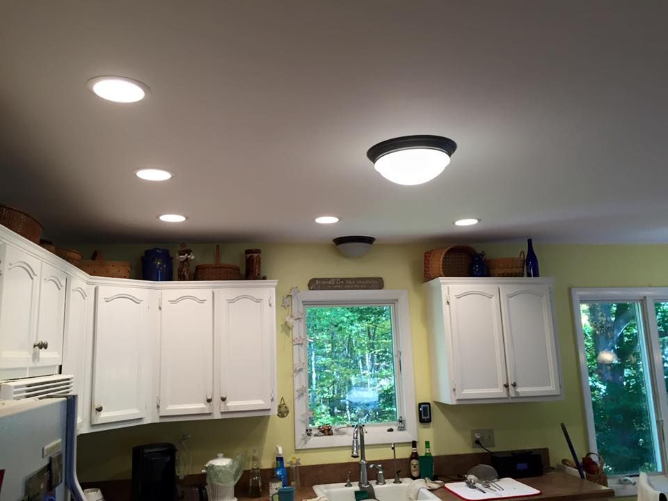A kitchen with white cabinets and a ceiling light
