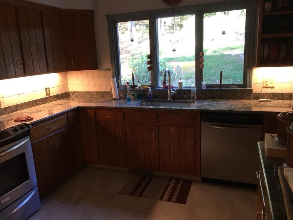 A kitchen with stainless steel appliances and wooden cabinets