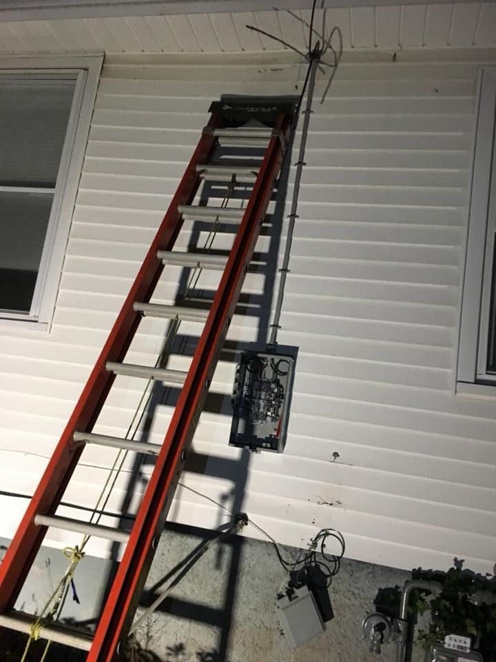 A ladder is leaning against the side of a house.