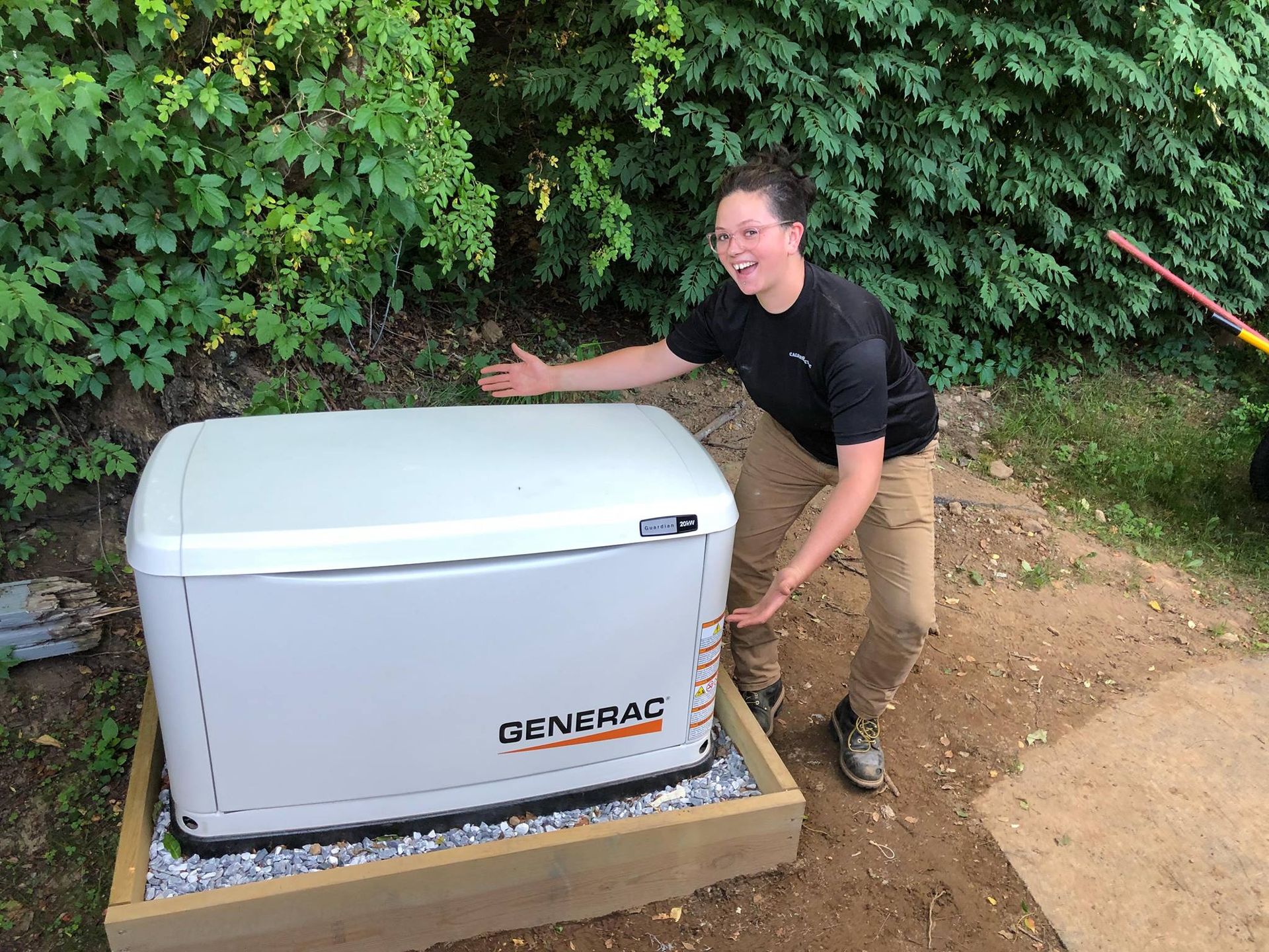 A man is standing next to a generator.