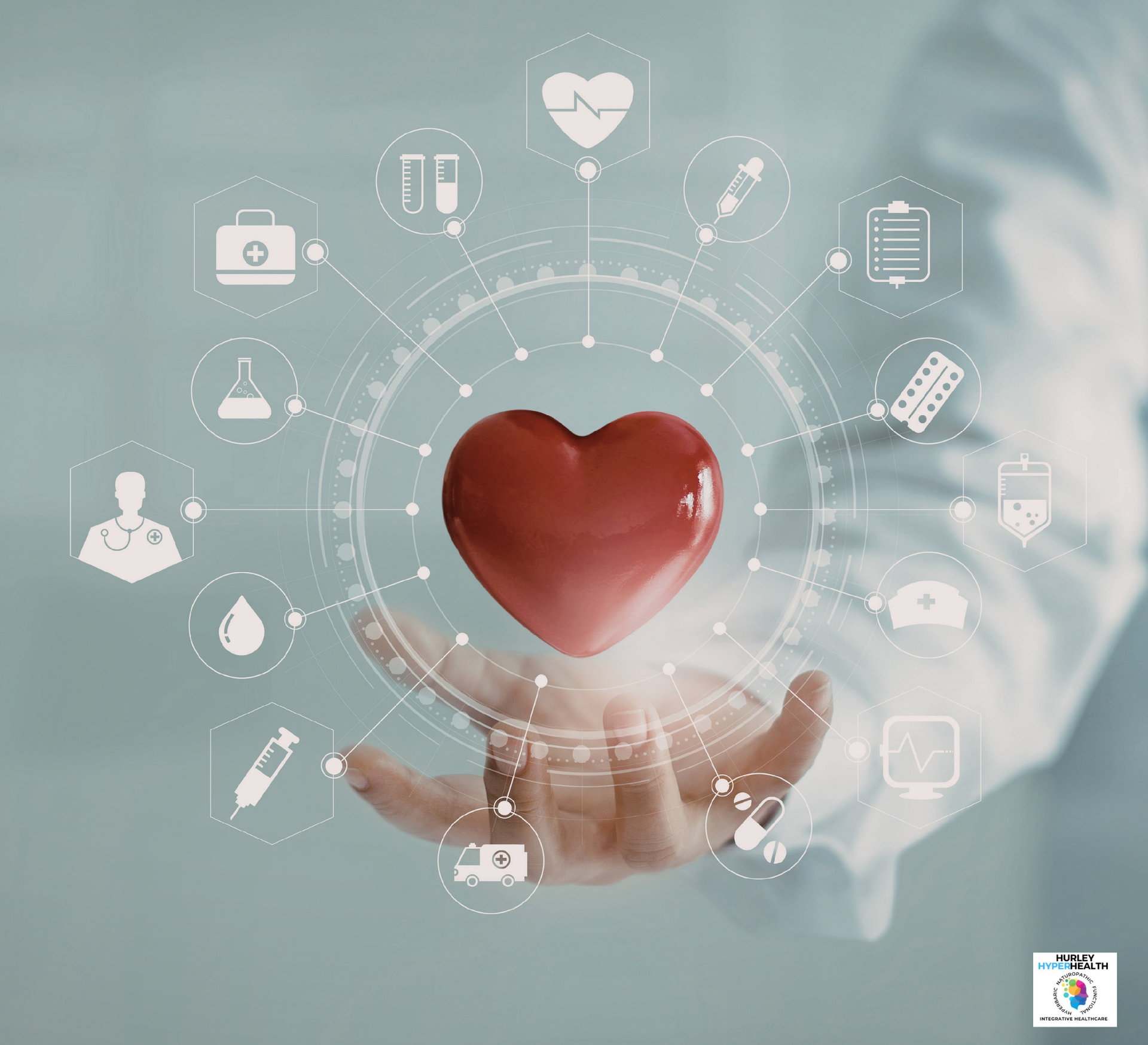 A person holds a red 3D heart surrounded by a digital interface of various medical icons in a healthcare setting.
