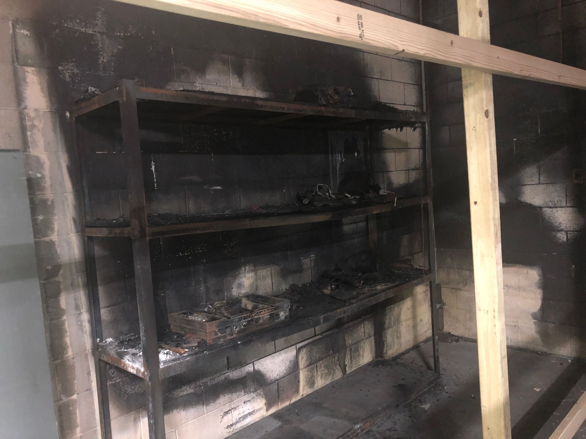 A room with a lot of shelves and a wooden beam.