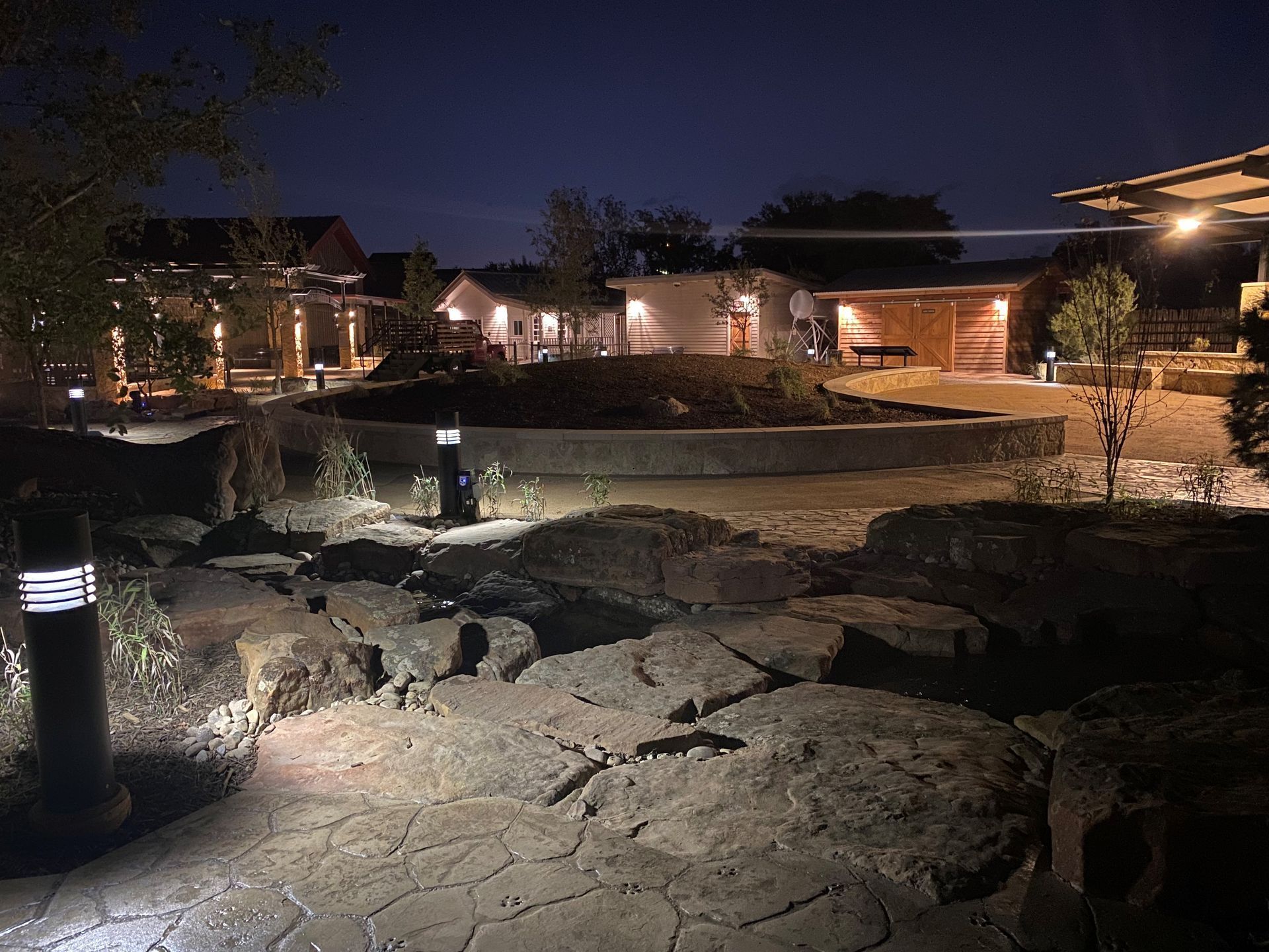 A house is lit up at night in a residential area.