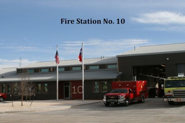 A fire station with a red truck parked in front of it