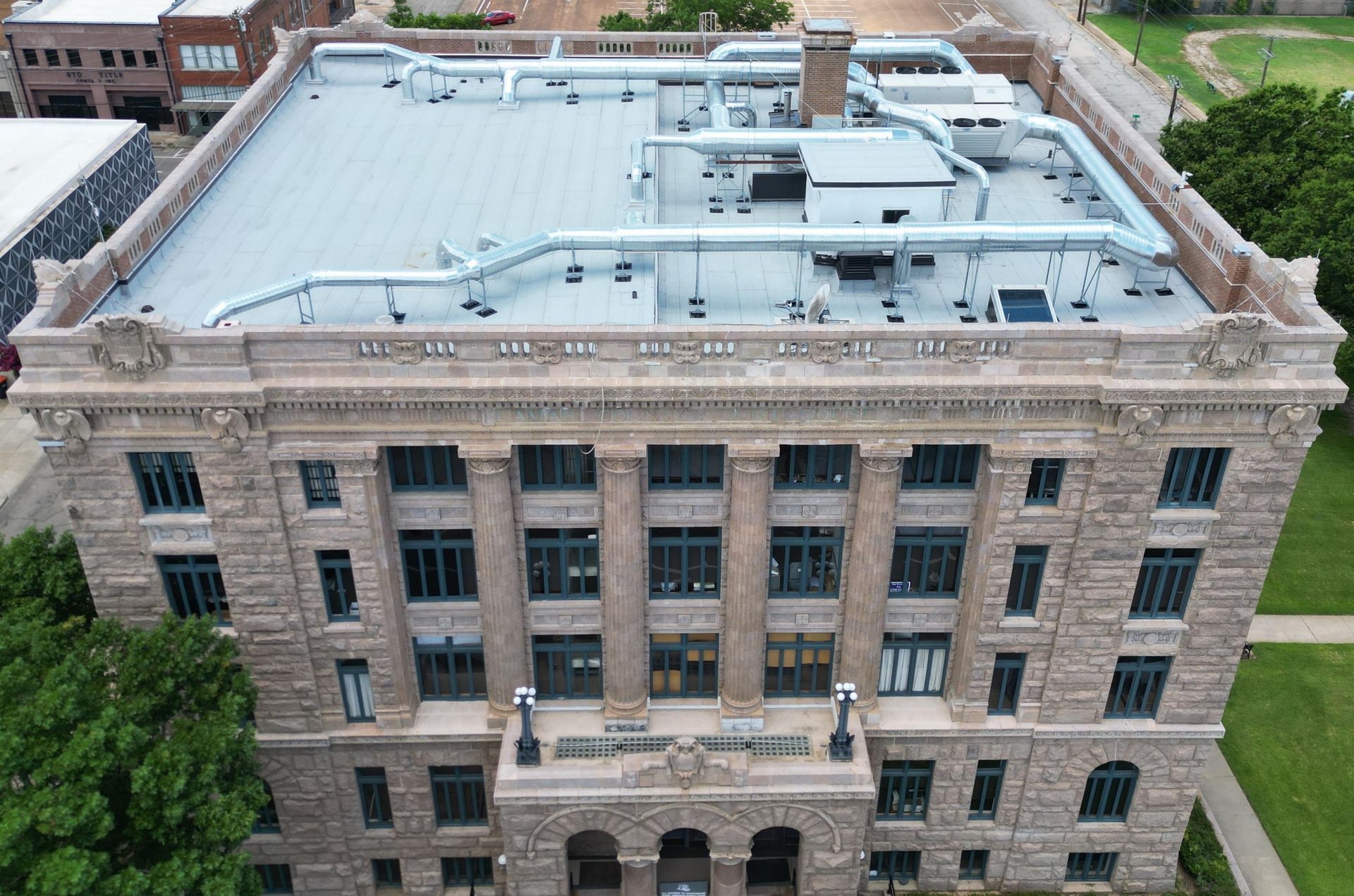 An aerial view of a large building with a flat roof