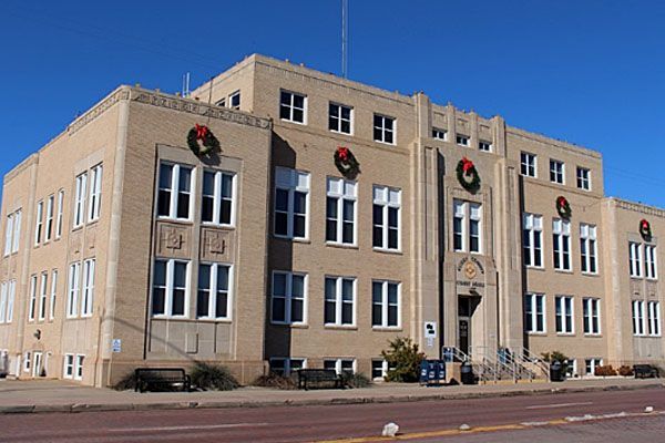 A large building with christmas wreaths on the windows