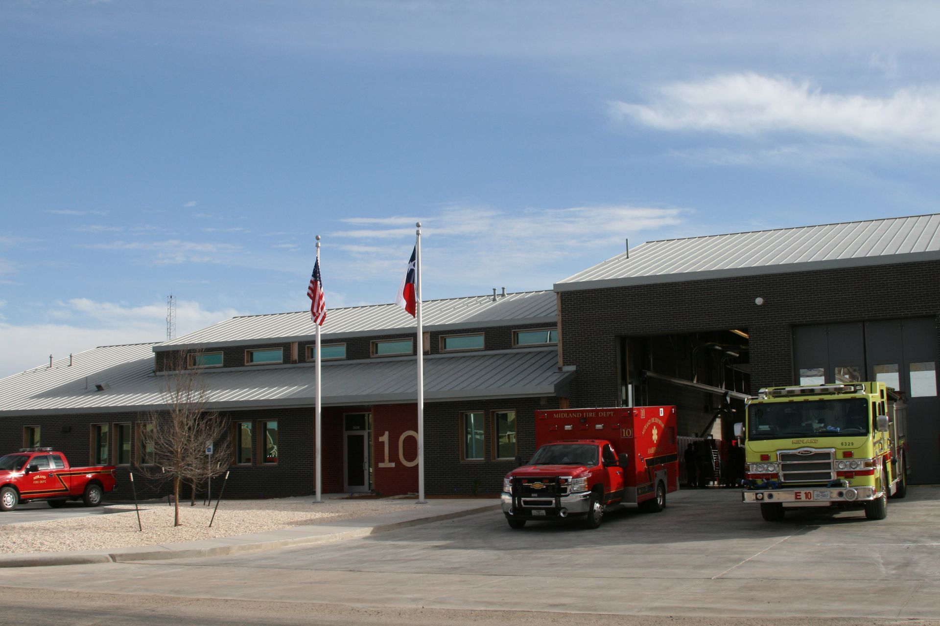 A fire station with a red truck parked in front of it