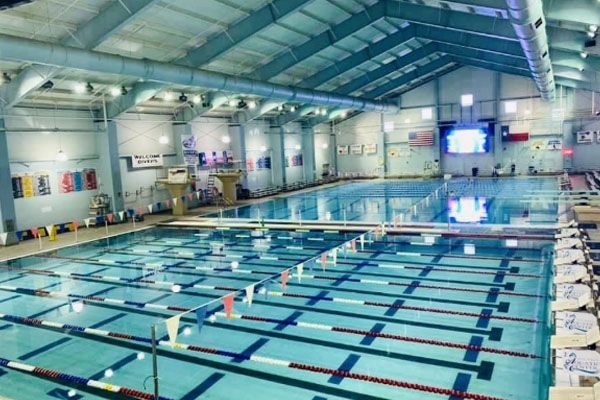 A large indoor swimming pool with a lot of lanes