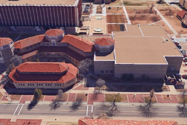 An aerial view of a large building with red tile roofs