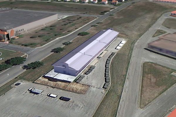 An aerial view of a large building in a parking lot