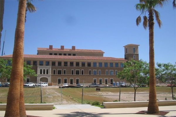 A large building with palm trees in front of it