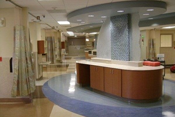 A hospital hallway with a counter in the middle