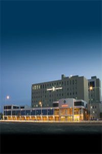 A large building with a blue sky in the background
