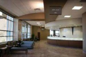 A waiting room in a hospital with a couch and a counter.