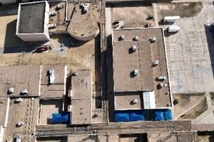 An aerial view of a building with a lot of roofs.