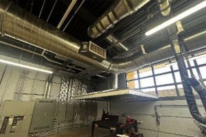 A large room with a lot of pipes hanging from the ceiling.