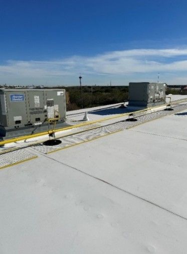 The roof of a building with a lot of air conditioners on it.