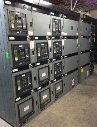 A row of electrical panels stacked on top of each other in a room.