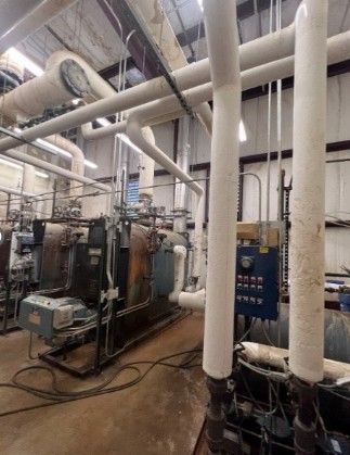 A room with a lot of pipes and machinery in it