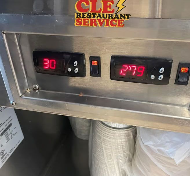Digital temperature displays showing 30 and 279, with power switches, on a restaurant machine.