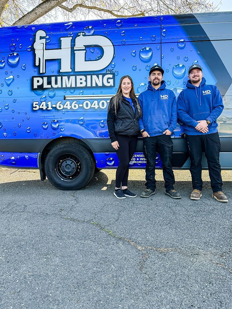 A group of people standing in front of a blue van.