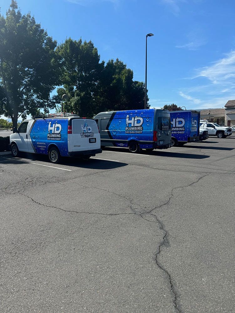A row of hd vans are parked in a parking lot