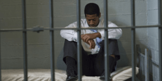 man-sitting-in-jail