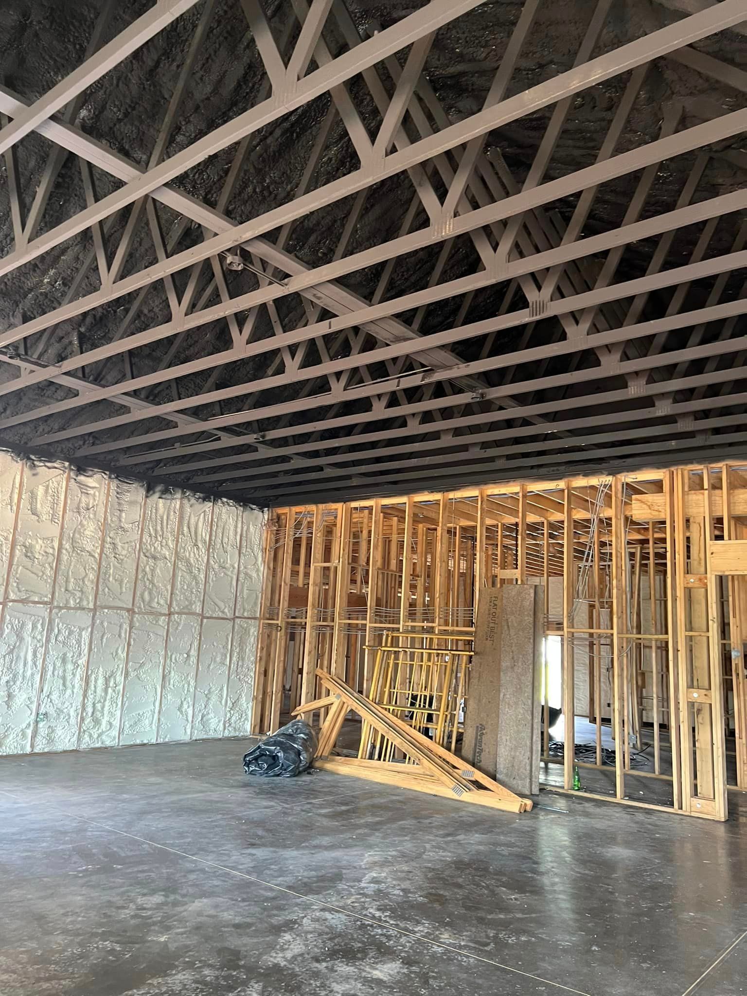 the inside of a building under construction with a lot of wooden beams .