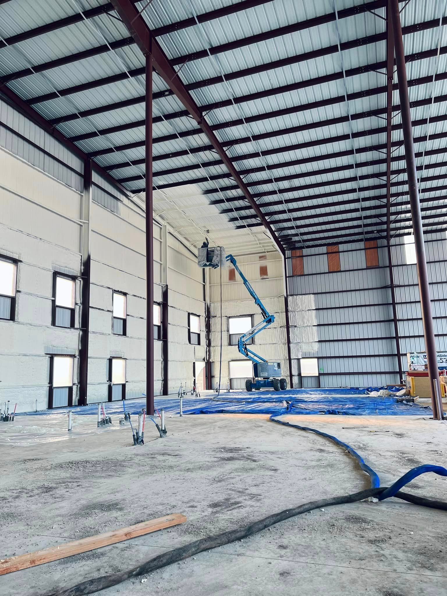 a large building under construction with a crane in the middle of it .