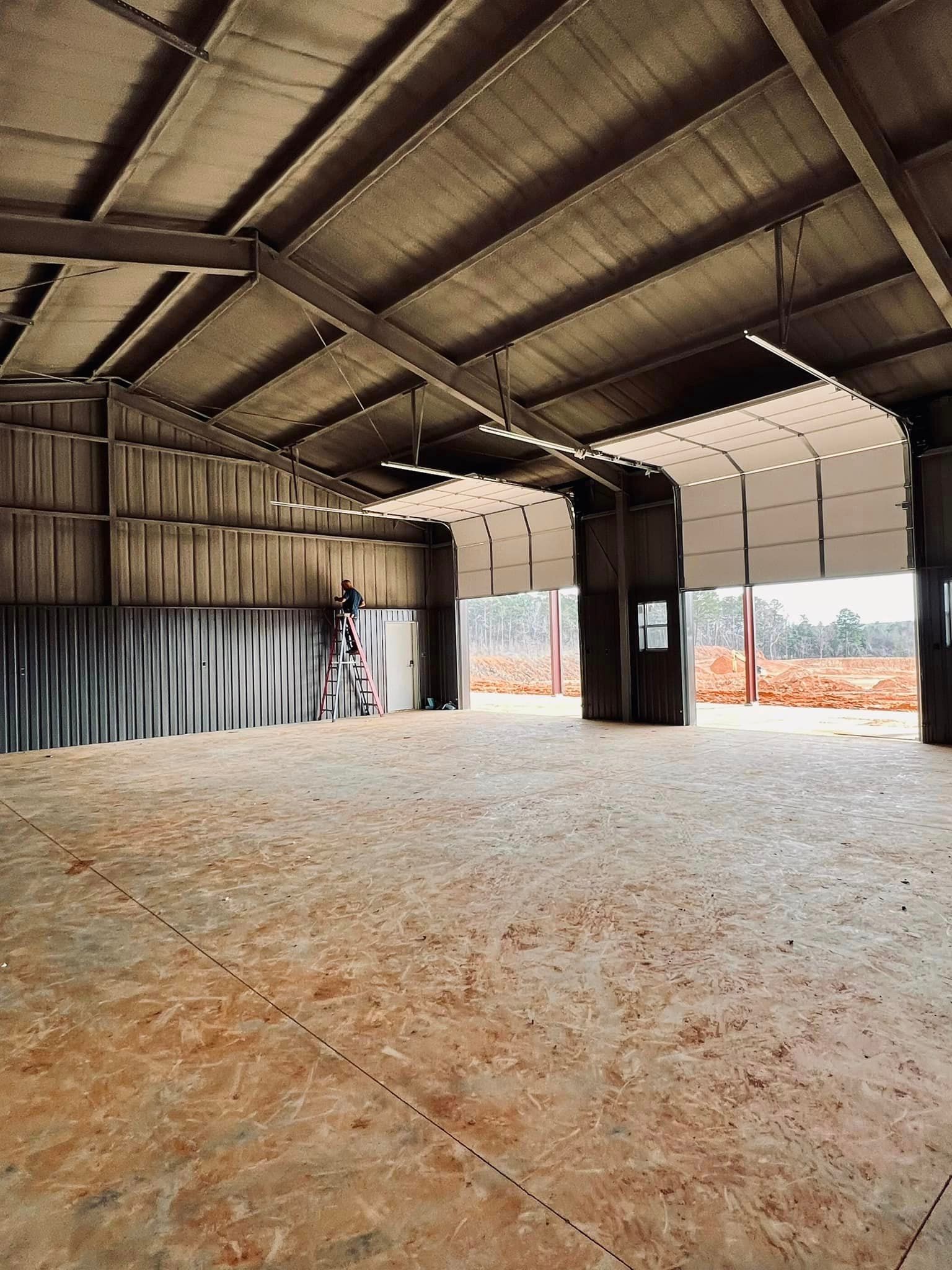 a large empty warehouse with a large garage door open .