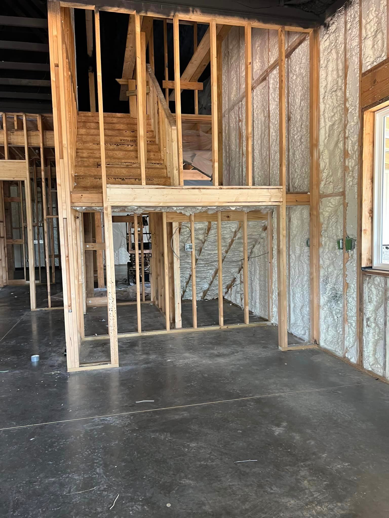a house is being built with a staircase in the middle of the room .