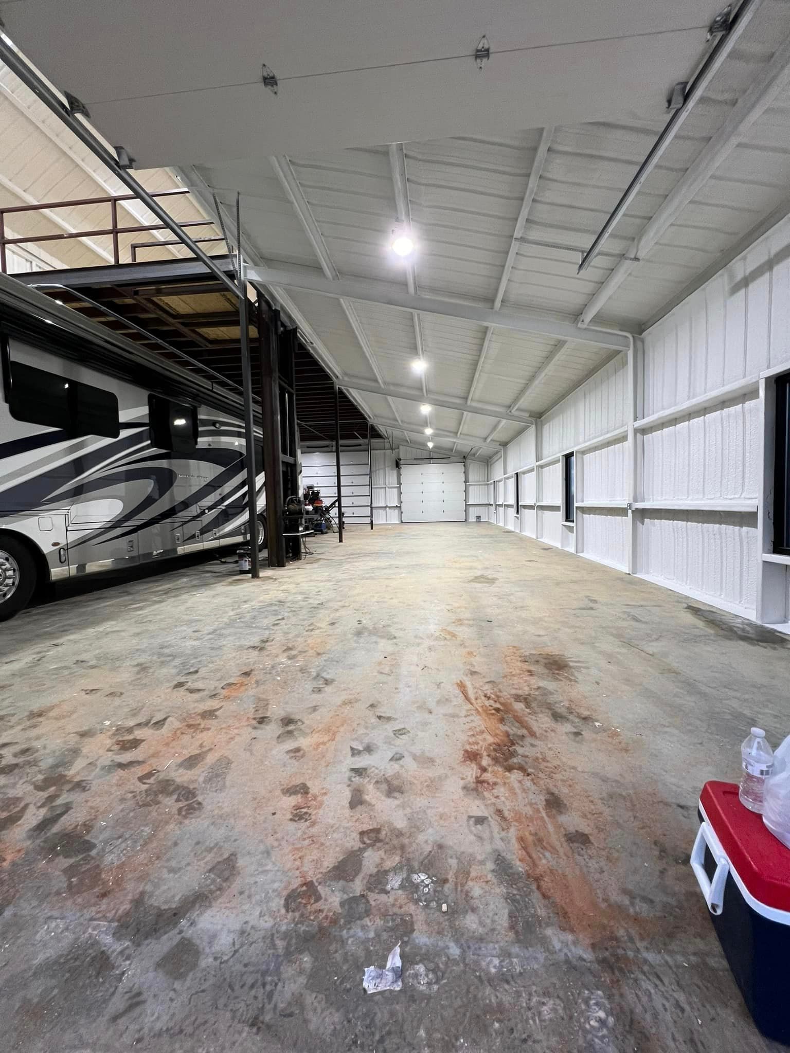a rv is parked inside of a large warehouse .