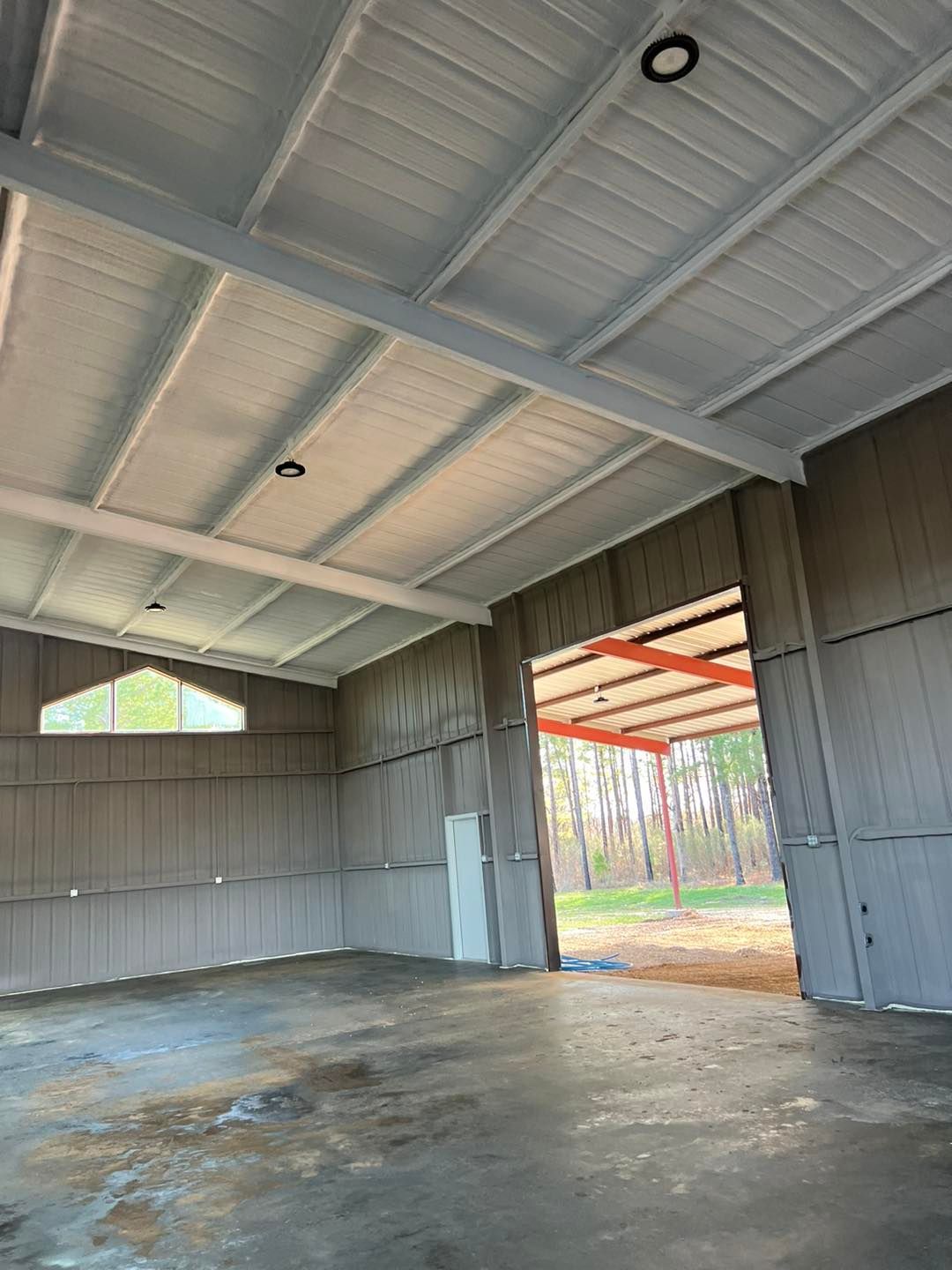 a large empty building with a concrete floor and a white ceiling .