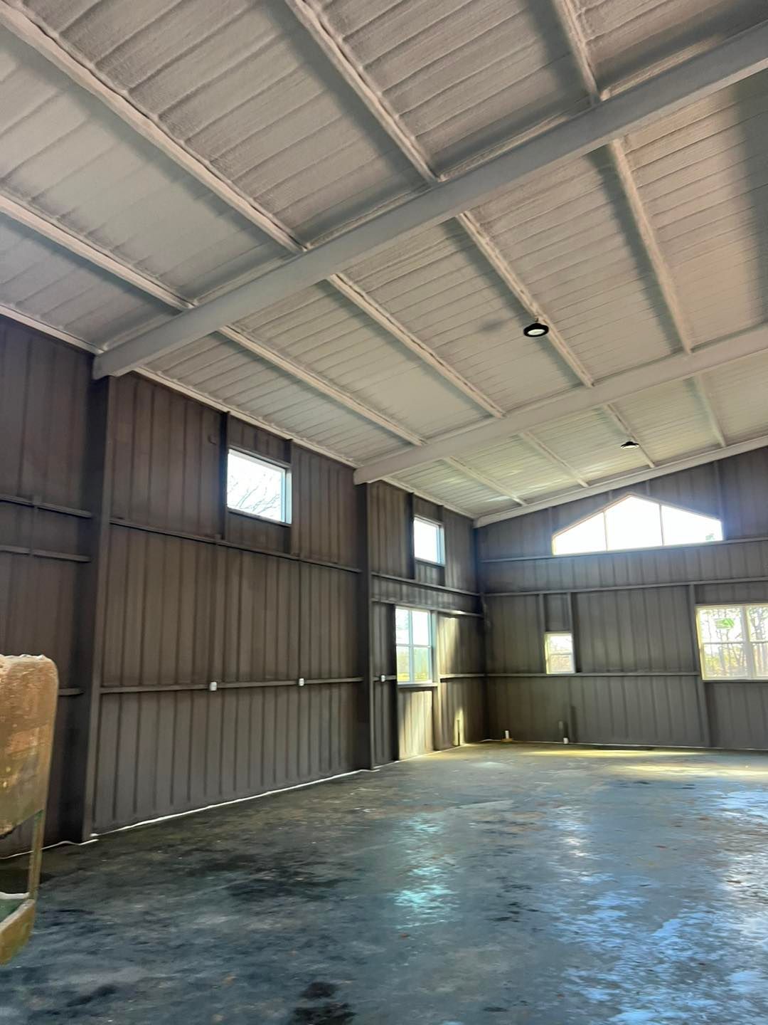 a large empty warehouse with a white ceiling and a lot of windows .