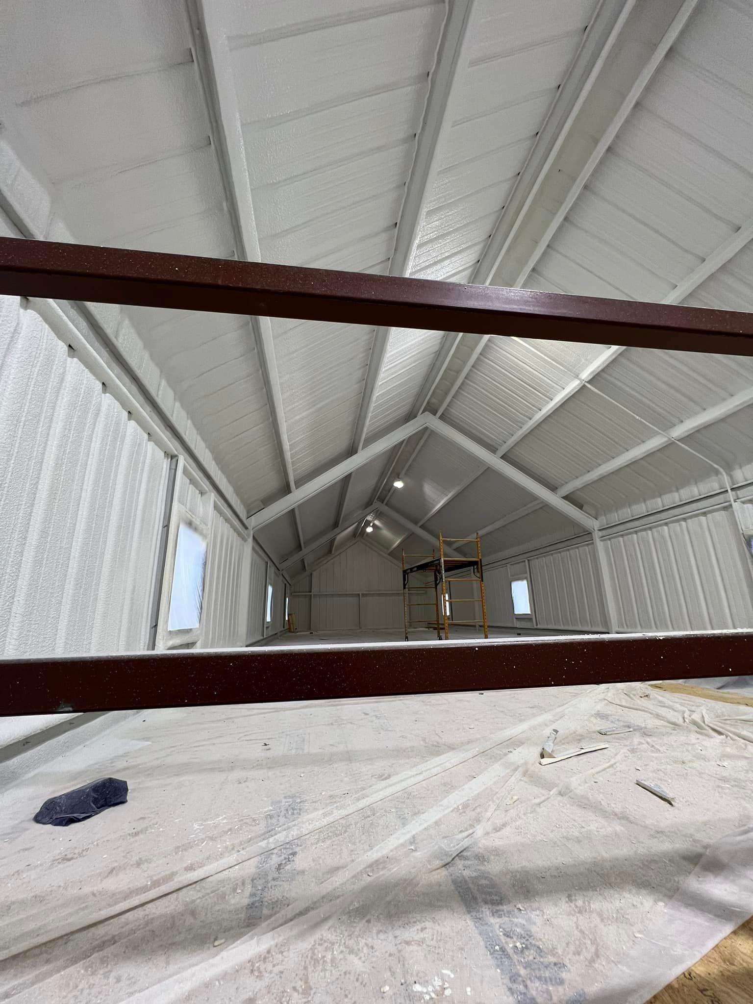 a large building with a roof that is being painted white .